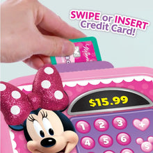 Hand inserting a card into a pink Minnie Mouse cash register keypad and display.