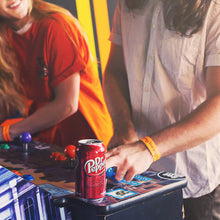 Dr Pepper soda can in hand, red can with Dr Pepper logo