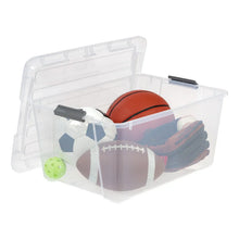 Clear plastic storage bin with open lid and black buckles, holding assorted sports gear