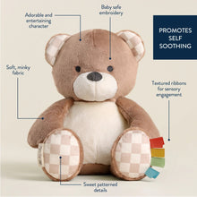 Plush bear with white muzzle and checkered pocket paws, multicolor ribbon sensory tails