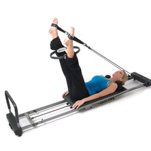 Pilates magic circle used during workout with straps on an exercise machine