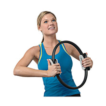Pilates magic circle ring with foam grips held in front of the chest