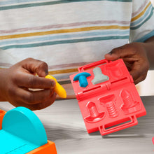 Red stamp tool tray with clay pieces and yellow and teal parts
