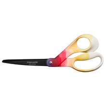 Scrapbook scissors with black blades and yellow-red patterned finger loops, non-stick
