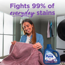 Purex liquid detergent bottle with lavender fields label, near a folded purple towel.