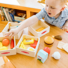 Open wooden food crates with stacked toy foods, including a burger, cheese, and egg shapes