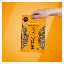 Wonderful honey roasted pistachios bag held in hand, no shells