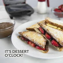 Triangular dessert sandwiches dusted with sugar and filled with berries
