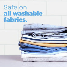Laundry detergent care message over a stack of folded, washable fabrics