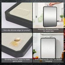 Double-sided cutting board with silicone edge and folding handle for hanging.