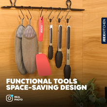 Set of kitchen tongs with silicone tips and locking handles hanging on hooks