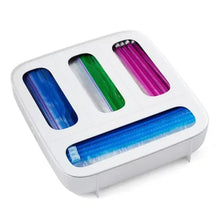 White plastic bag dispenser with blue, green, and pink rolls in slots