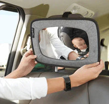 Backseat baby mirror with gray frame, held up to rear-facing child for viewing