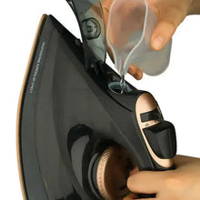 Electric steam iron close-up with steam vents on the soleplate and control buttons