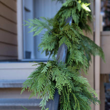 Evergreen cedar garland with dense pine-like foliage and a looped hanging design