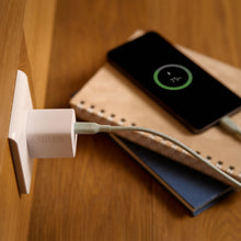 White Anker 33W wall charger connected by cable to a device