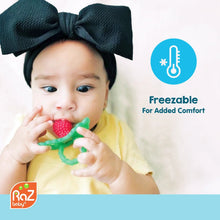 RaZberry silicone teether toy, red textured berry with green handle held by baby.