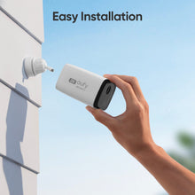 eufy SoloCam C210 wireless outdoor camera in white housing, being mounted on exterior wall
