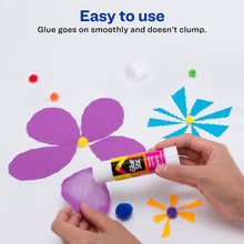 White glue stick applied by hands on purple flower paper craft