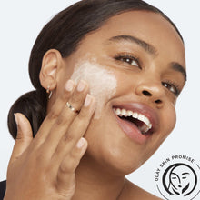 Facial cleanser lather on cheek, woman smiling with hands on face