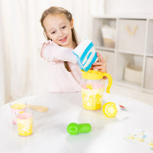 Child pouring from a blue carton into a yellow lemonade pretend play toy pitcher