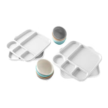 Set of white divided microwave-safe trays with stacked nesting bowls in teal and beige