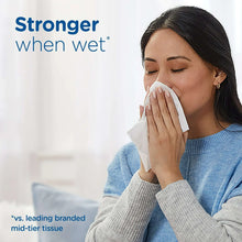 Woman wiping her face with a white facial tissue, Ultra Soft
