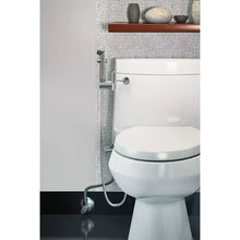 Installed handheld bidet setup with chrome hose and sprayer mounted beside toilet