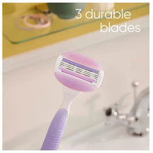 Gillette Venus razor head with three blades on pink/purple shaver