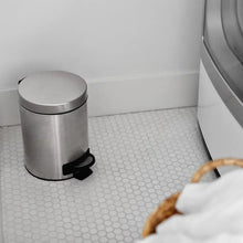 Stainless steel step-on trash can with round lid and black pedal