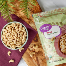 Organic raw whole cashews pouch beside a bowl of whole cashews