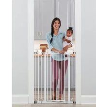 White metal walk-through baby gate with vertical bars, installed at doorway