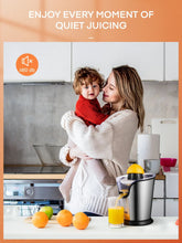 Stainless steel electric citrus juicer on kitchen counter with a child holding juice