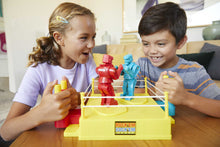 Kids playing a fighting robot board game with red and blue robots on yellow