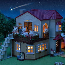 Lighted dollhouse playset at night, cream walls, red roof, and glowing windows