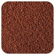 Brown instant coffee granules with fine powder texture