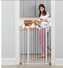 White metal walk-through baby gate with vertical bars, viewed from open entry