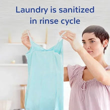 Light blue shirt held during rinse-cycle sanitizing treatment