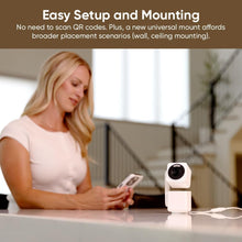White indoor/outdoor smart security camera on desk, with person using phone