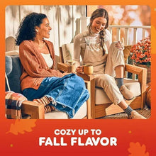 Two people sipping coffee together with an autumn-themed Dunkin Pumpkin Spice ad