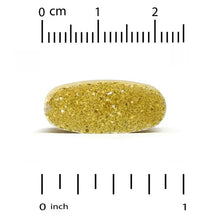 Single greenish-yellow multivitamin tablet with size ruler marks