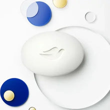 White Dove beauty bar soap with oval logo, on a glossy surface