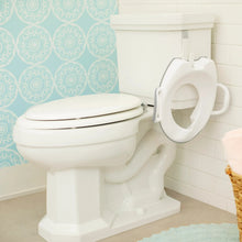 Toddler potty seat with built-in side handles on toilet, light-colored