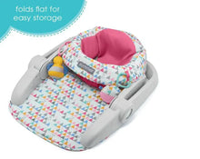 Adjustable baby floor seat, folded flat, with pink inner pad and geometric fabric