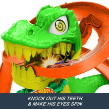 Green T-rex figure on orange dinosaur track with big open mouth and eye detail