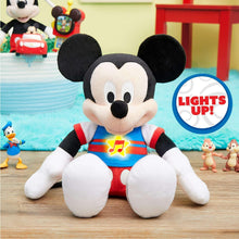 Singing Mickey Mouse plush toy with Lights Up badge, blue shirt and red shorts