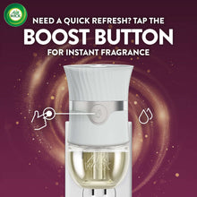 Air Wick plug-in scented oil warmer with clear refill cup and white housing