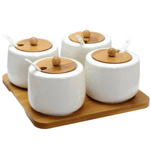 Ceramic condiment containers with wooden lids and knobs, four-piece set on tray