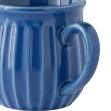 Blue stoneware mug close-up showing ridged texture and handle