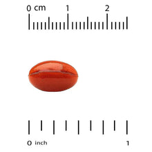 Red softgel beside a ruler scale with 0 to 1 inch marks